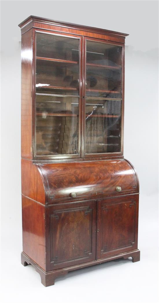 An early 19th century mahogany cylinder bureau bookcase, marked for T. Wilson, Great Queen Street, London, H.7ft 11in.